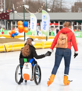 Two Women, One in Wheelchair, Ice Skating